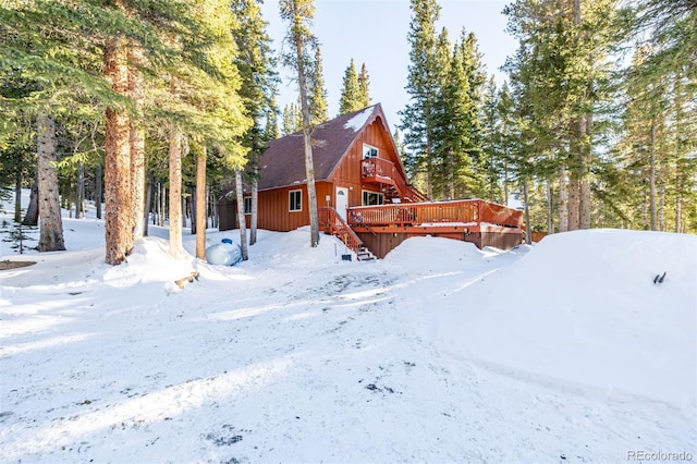 yard covered in snow featuring a wooden deck