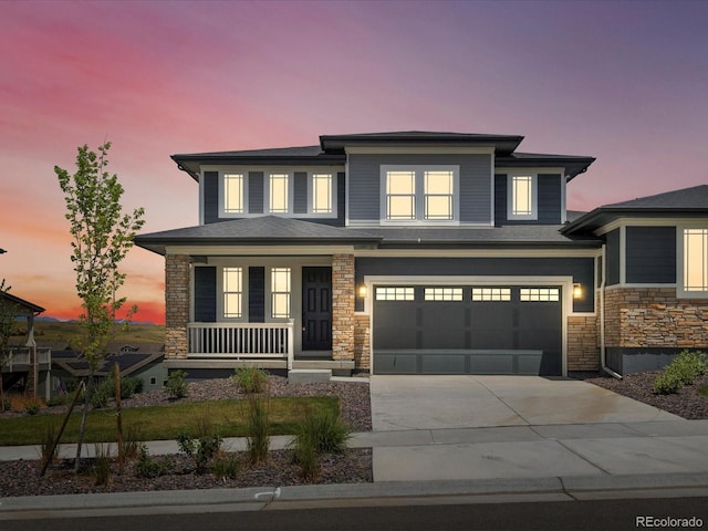 17843 W 93rd Pl, Arvada, CO 80007 - prairie-style home with stone siding, driveway, a garage, and a porch