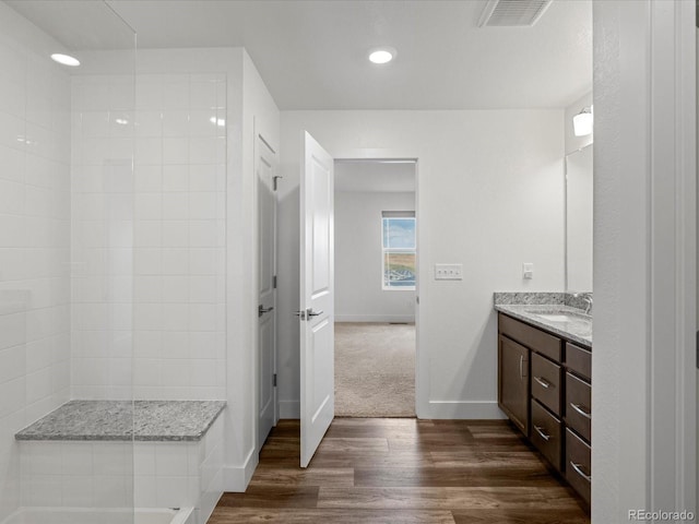 17843 W 93rd Pl, Arvada, CO 80007 - bathroom featuring vanity, wood finished floors, recessed lighting, and tiled shower