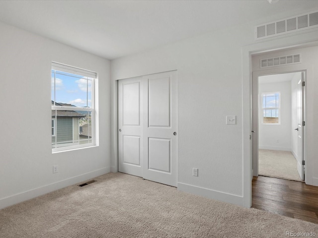 17843 W 93rd Pl, Arvada, CO 80007 - unfurnished bedroom with multiple windows, carpet floors, and a closet