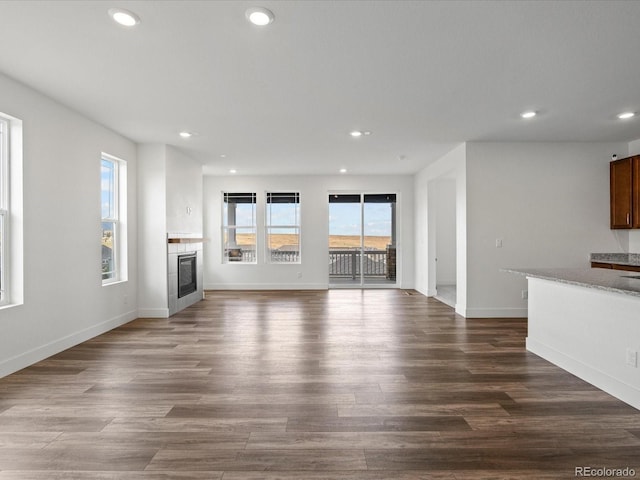 17843 W 93rd Pl, Arvada, CO 80007 - unfurnished living room with a fireplace, recessed lighting, and dark wood-style floors