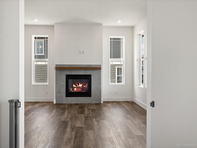 17843 W 93rd Pl, Arvada, CO 80007 - unfurnished living room with wood finished floors and a tile fireplace