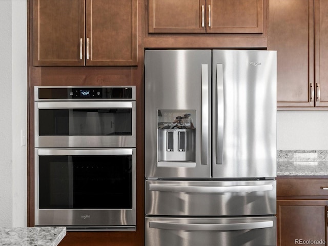 17843 W 93rd Pl, Arvada, CO 80007 - kitchen with appliances with stainless steel finishes and light stone counters