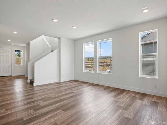 17843 W 93rd Pl, Arvada, CO 80007 - unfurnished room with wood finished floors, plenty of natural light, recessed lighting, and stairs