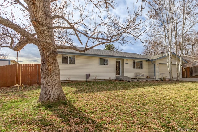 view of front of house with a garage and a front lawn