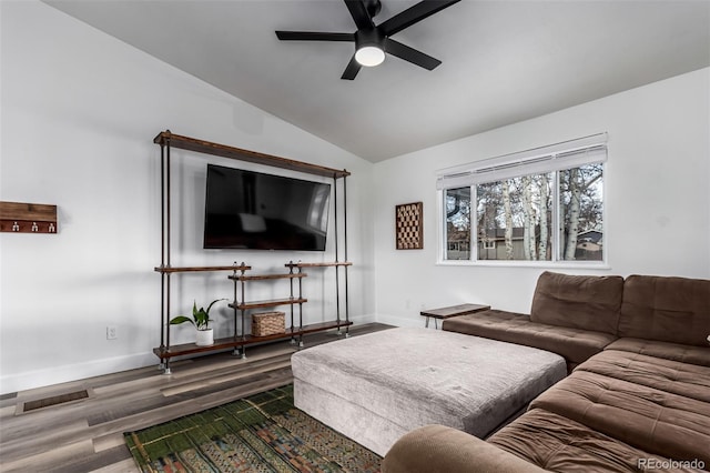 living room featuring dark hardwood / wood-style floors, ceiling fan, and lofted ceiling