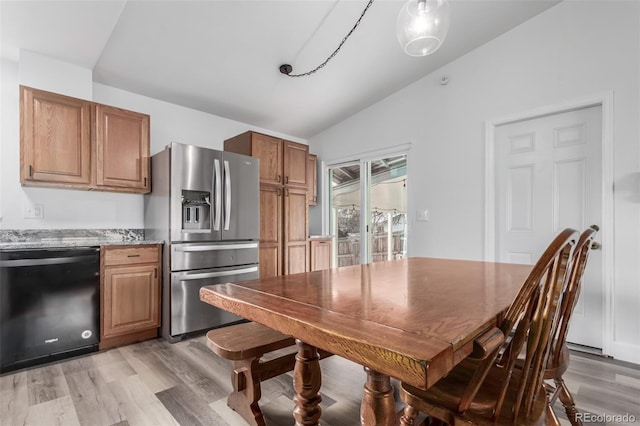 kitchen with light stone countertops, dishwasher, stainless steel refrigerator with ice dispenser, lofted ceiling, and light wood-type flooring