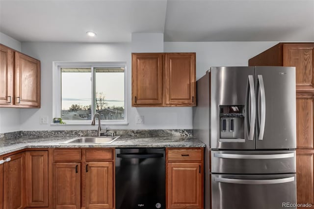 kitchen with dishwasher, stainless steel fridge, and sink