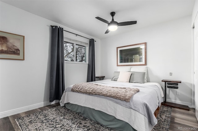 bedroom featuring ceiling fan and dark hardwood / wood-style flooring