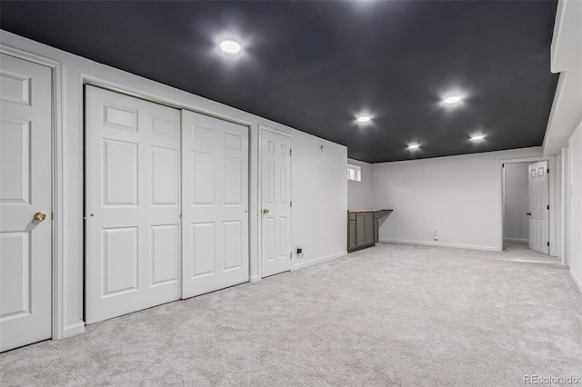 basement featuring light colored carpet