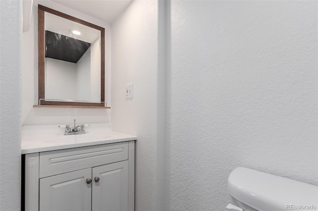 bathroom featuring vanity and toilet