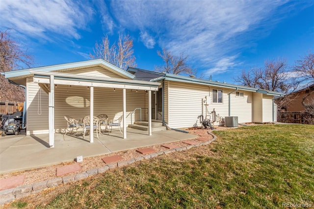 back of property with central AC, a yard, and a patio