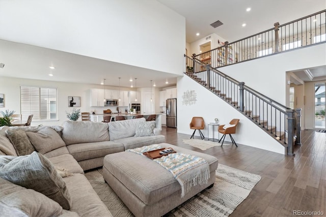 living room featuring a wealth of natural light and dark hardwood / wood-style flooring