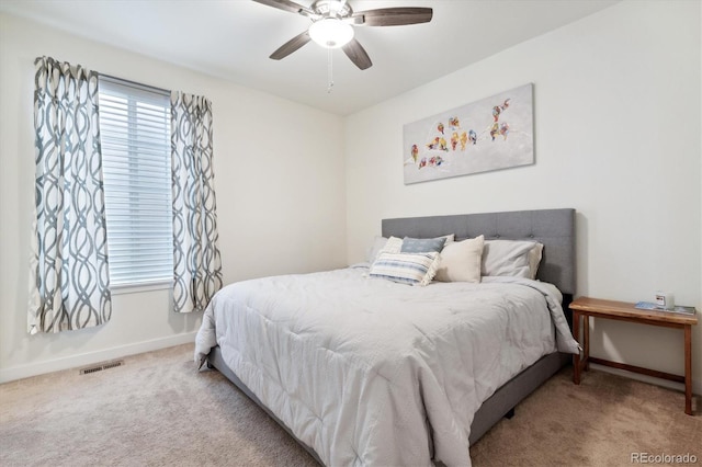 bedroom featuring light carpet and ceiling fan