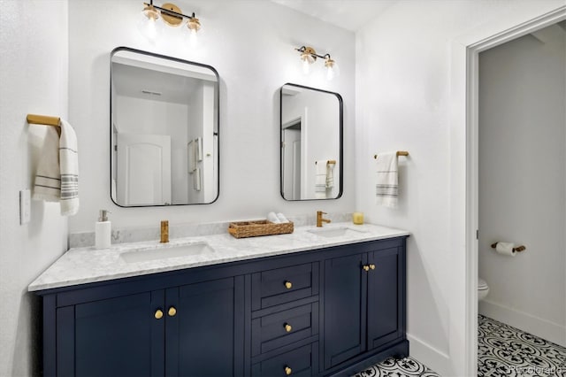 bathroom with tile patterned floors, vanity, and toilet