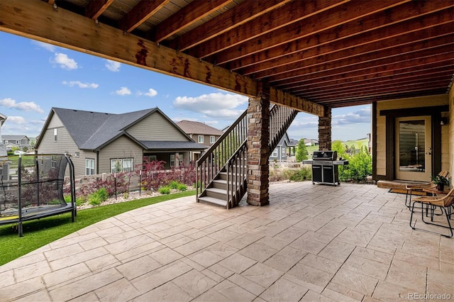 view of patio / terrace featuring a grill and a trampoline