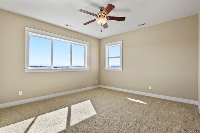 spare room with carpet and ceiling fan