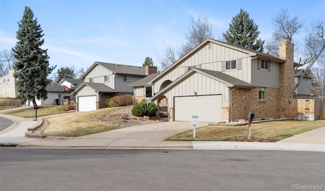 3765 S Depew St, Denver, CO 80235 - view of front of property with fence, a chimney, board and batten siding, a front yard, and driveway