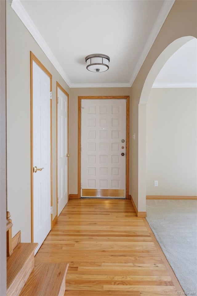 3765 S Depew St, Denver, CO 80235 - interior space with light wood finished floors, ornamental molding, arched walkways, and baseboards
