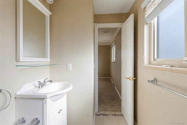 3765 S Depew St, Denver, CO 80235 - bathroom featuring tile patterned floors, baseboards, and vanity