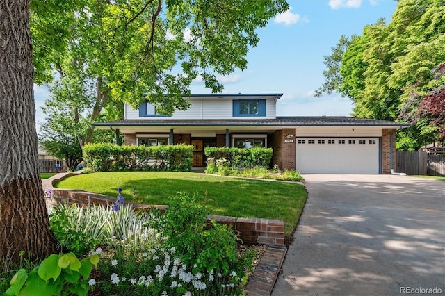 1998 S Harlan Ct, Lakewood, CO 80227 - view of front of property with concrete driveway, a garage, and brick siding