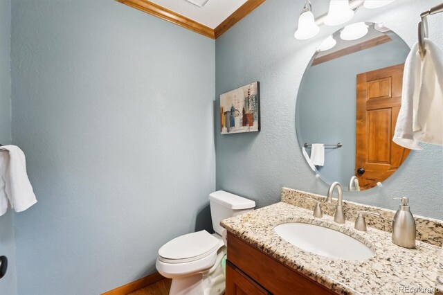 1998 S Harlan Ct, Lakewood, CO 80227 - bathroom with vanity, crown molding, toilet, and a textured wall
