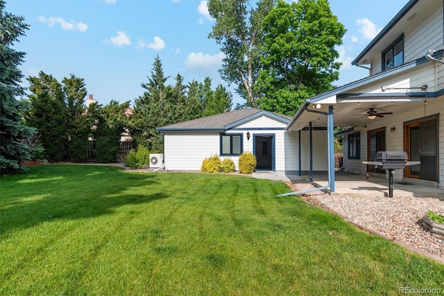 1998 S Harlan Ct, Lakewood, CO 80227 - view of grassy yard featuring a ceiling fan, a patio area, and an outdoor structure