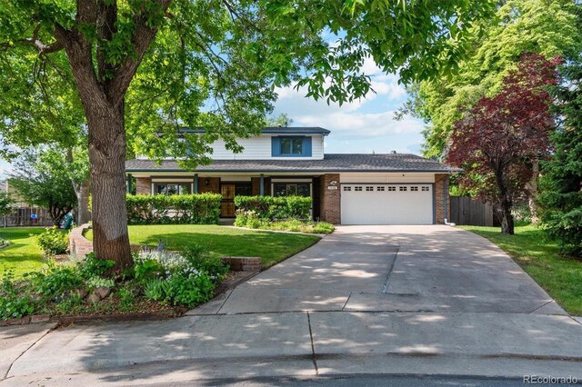 1998 S Harlan Ct, Lakewood, CO 80227 - traditional-style house with an attached garage, driveway, and brick siding