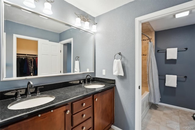 1998 S Harlan Ct, Lakewood, CO 80227 - bathroom with double vanity, shower / tub combo, tile patterned floors, and a spacious closet