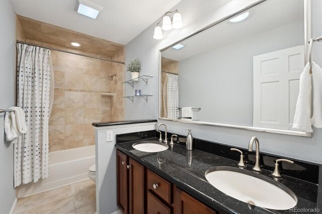 1998 S Harlan Ct, Lakewood, CO 80227 - bathroom with tile patterned flooring, double vanity, toilet, and shower / tub combo with curtain