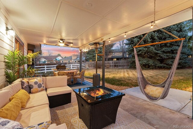 1998 S Harlan Ct, Lakewood, CO 80227 - patio terrace at dusk with an outdoor living space with a fire pit, a patio, outdoor dining space, and ceiling fan