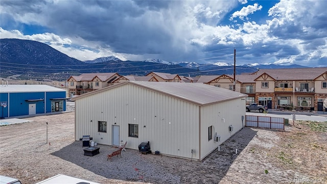 view of property exterior featuring a mountain view and a garage