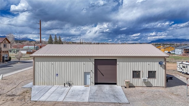 view of outdoor structure with a mountain view and a garage