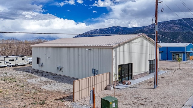 view of side of home featuring a mountain view