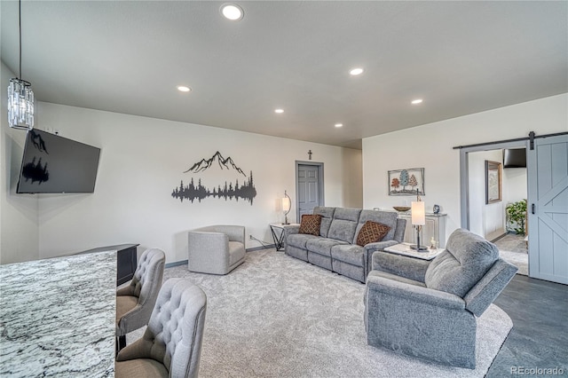 carpeted living room featuring a barn door