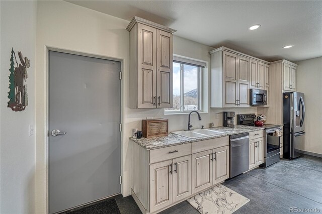 kitchen with stainless steel appliances, sink, and light stone countertops