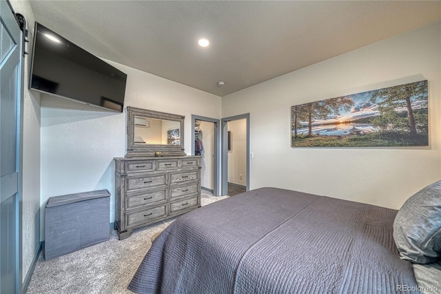 bedroom featuring carpet and a barn door