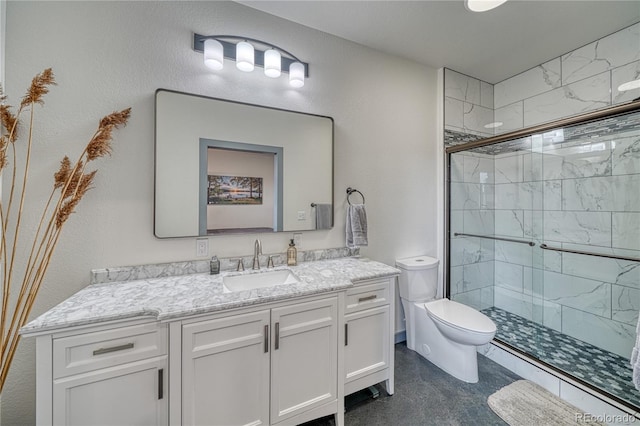 bathroom with a shower with shower door, toilet, tile floors, and vanity