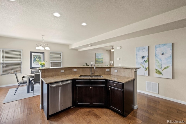 10414 Declaration Dr, Colorado Springs, CO 80925 - kitchen featuring dishwasher, hardwood / wood-style floors, a textured ceiling, light stone counters, and recessed lighting