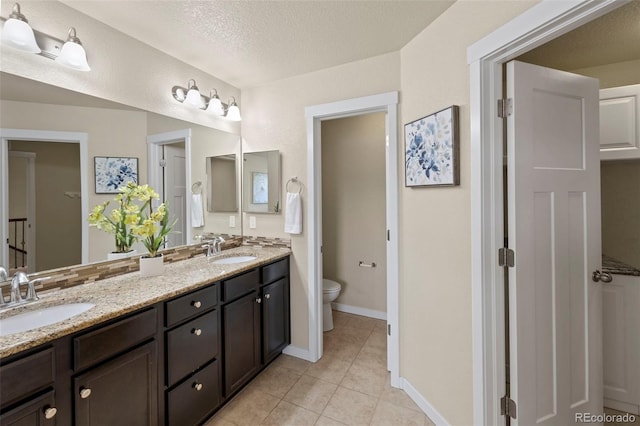 10414 Declaration Dr, Colorado Springs, CO 80925 - bathroom with double vanity and tile patterned floors