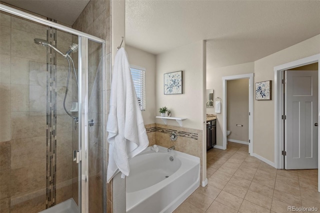 10414 Declaration Dr, Colorado Springs, CO 80925 - bathroom with a bath, a shower stall, tile patterned flooring, a textured ceiling, and vanity