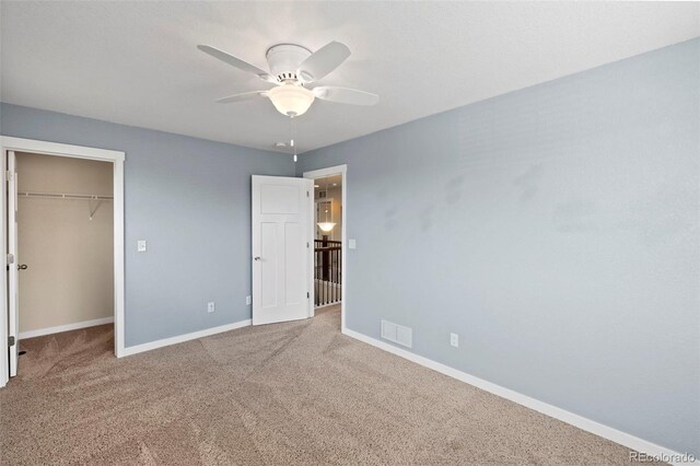 10414 Declaration Dr, Colorado Springs, CO 80925 - unfurnished bedroom with carpet flooring, a walk in closet, and ceiling fan