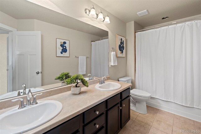 10414 Declaration Dr, Colorado Springs, CO 80925 - bathroom featuring double vanity, tile patterned flooring, and shower / bath combination with curtain