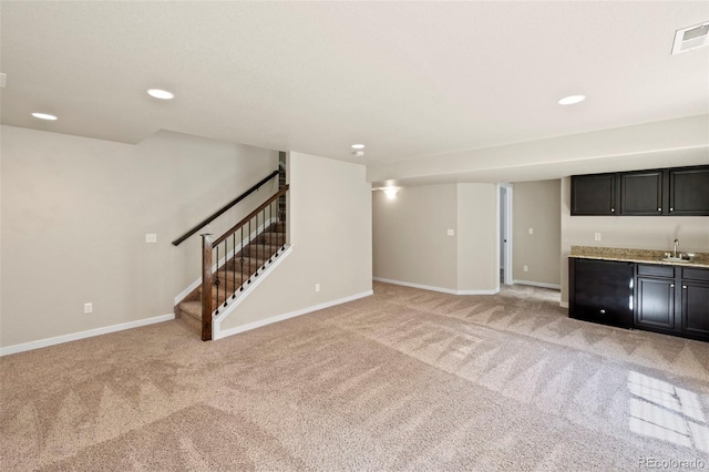 10414 Declaration Dr, Colorado Springs, CO 80925 - unfurnished living room with bar with sink, light carpet, stairs, and recessed lighting
