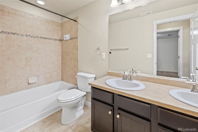 10414 Declaration Dr, Colorado Springs, CO 80925 - bathroom with double vanity, tile patterned floors, and shower / tub combination
