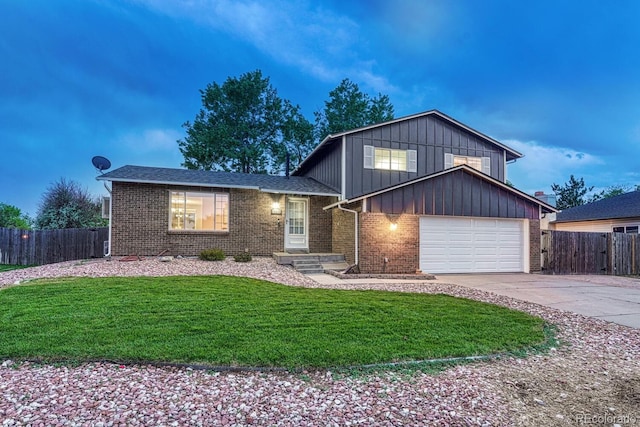 15918 E Flora Pl, Aurora, CO 80013 - split level home featuring concrete driveway, brick siding, a garage, and board and batten siding