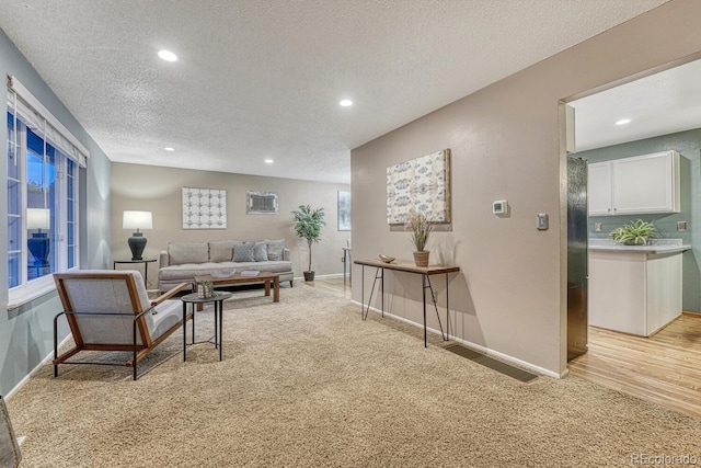 15918 E Flora Pl, Aurora, CO 80013 - living room with light carpet, a textured ceiling, baseboards, and recessed lighting