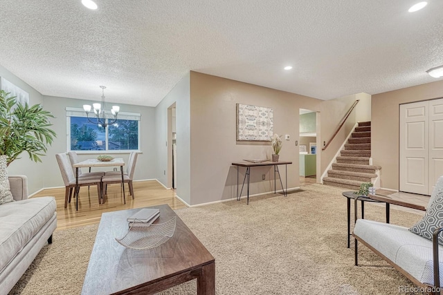15918 E Flora Pl, Aurora, CO 80013 - living room featuring stairway, a chandelier, a textured ceiling, recessed lighting, and baseboards