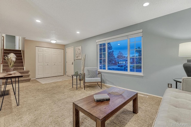 15918 E Flora Pl, Aurora, CO 80013 - living area with carpet flooring, stairway, recessed lighting, a textured ceiling, and baseboards
