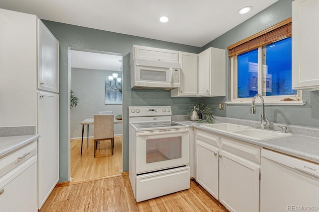 15918 E Flora Pl, Aurora, CO 80013 - kitchen with white appliances, a sink, light wood-style flooring, white cabinets, and recessed lighting
